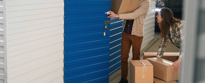 Couple putting box in storage