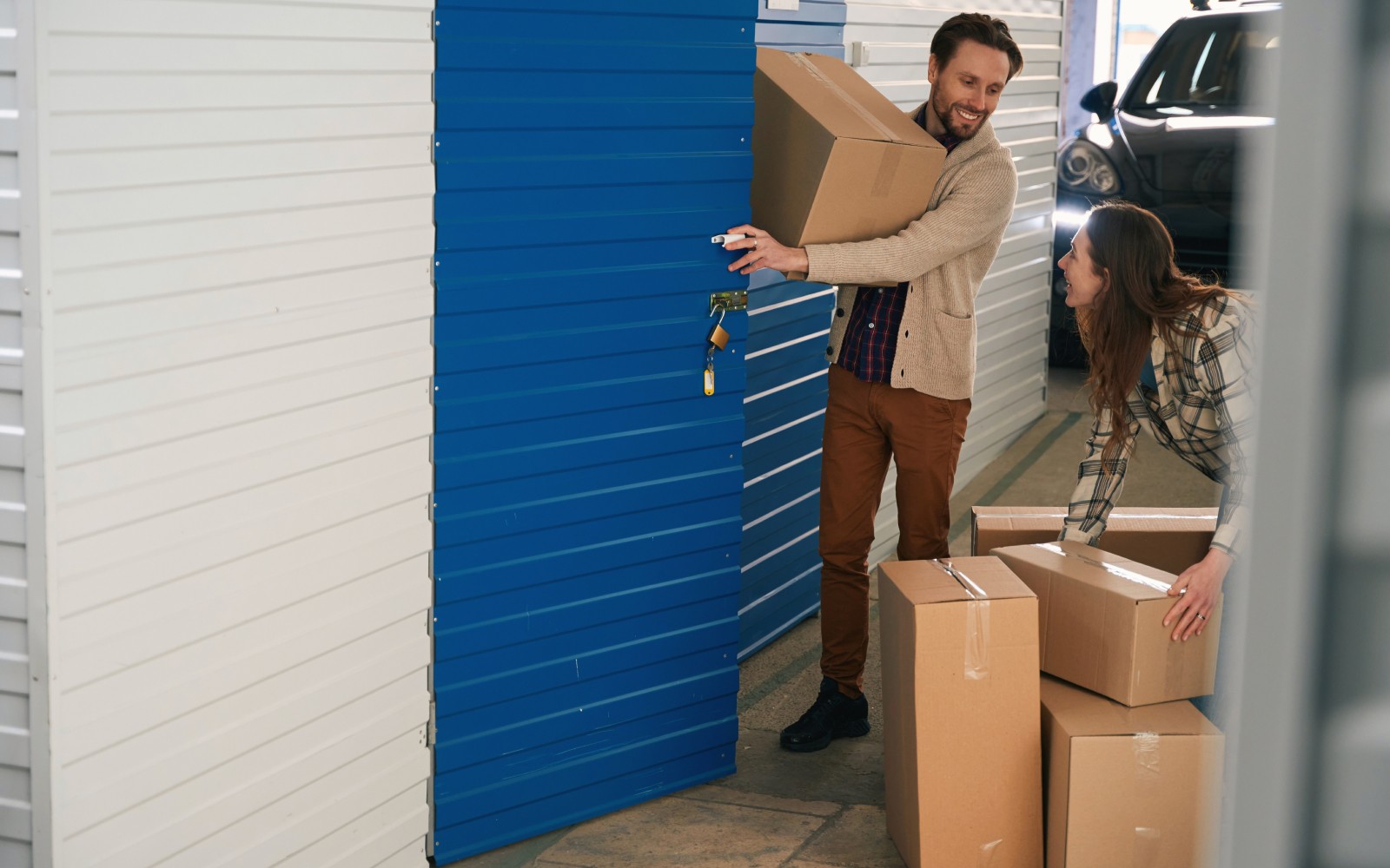 Couple putting box in storage